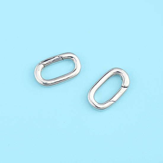 A slim oval carabiner with a spring gate along one long side — plain, highly polished metal with no texture or seam…
