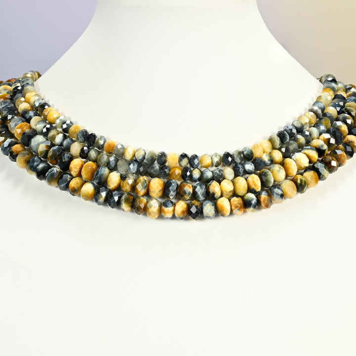 Dream Tiger Eye faceted rondelle beads shown on a white neck display, several 15 inch strands sitting together like a collar at 4x6mm and 5x8mm.