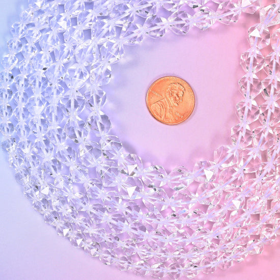 Clear Quartz diamond star cut beads coiled around a US penny for size reference