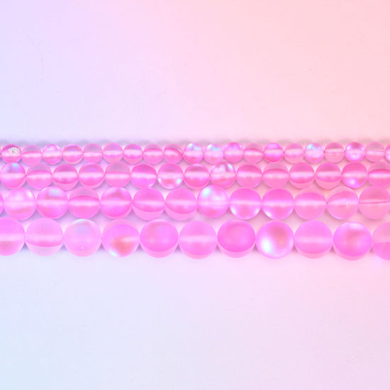 Matte glass beads in bright bubblegum pink with a moonstone-like flash