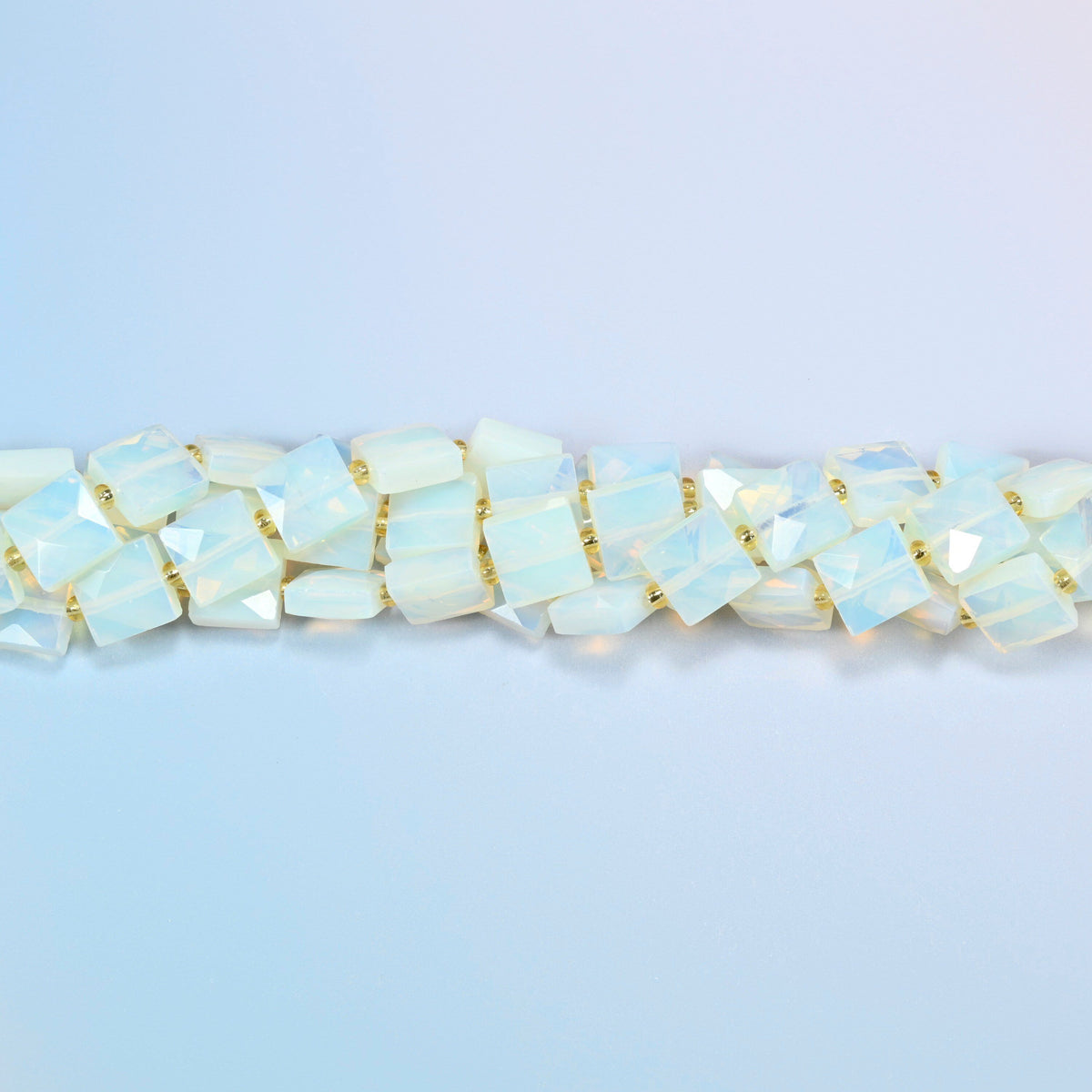 Strands of opalite faceted flat square beads twisted together in a horizontal row