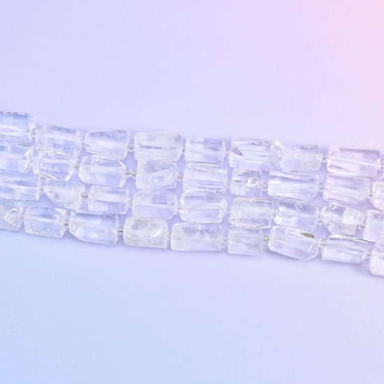 Three strands running diagonally on pale lilac, each tube showing its flat cut faces and internal veils