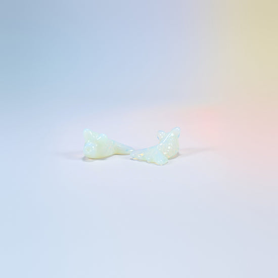Two 1.5 inch opalite goldfish carvings, milky man-made glass with a soft glow