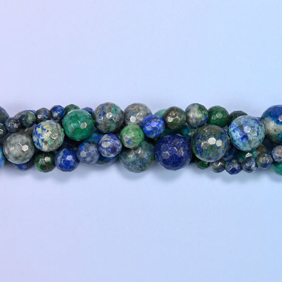 Phoenix Lapis Faceted Round Beads, deep navy blue pooled against jade and teal green with a grey-brown matrix