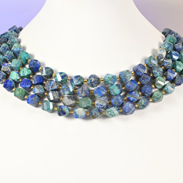 Phoenix Lapis lapis lazuli beads showing grey matrix and small gold pyrite specks catching the light on the 10mm faceted beads