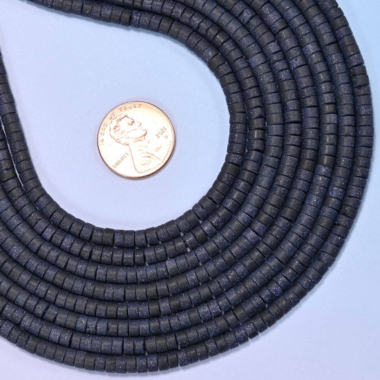 Blue sandstone (man-made glass) matte heishi disc beads in deep blue with shimmering copper flecks.