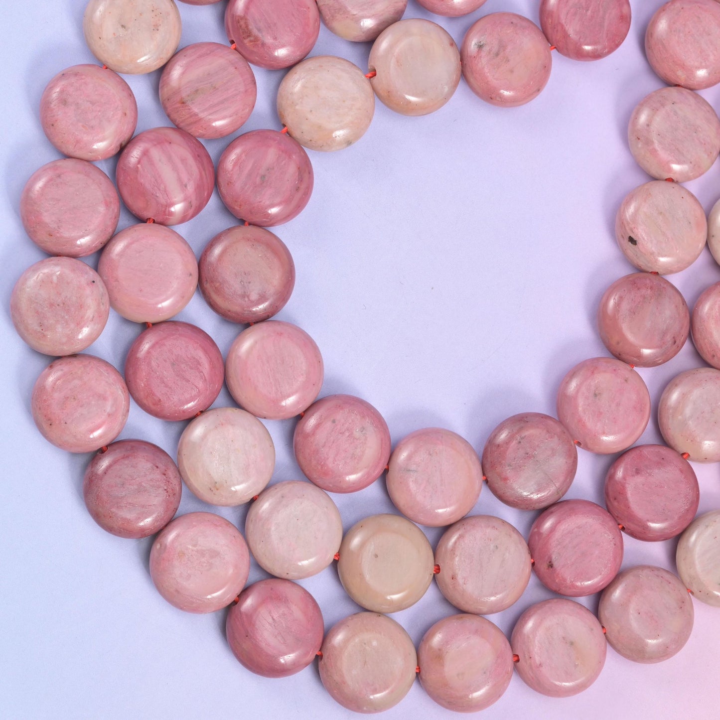 Pink Rhodonite coin beads, approximately 26 beads per strand