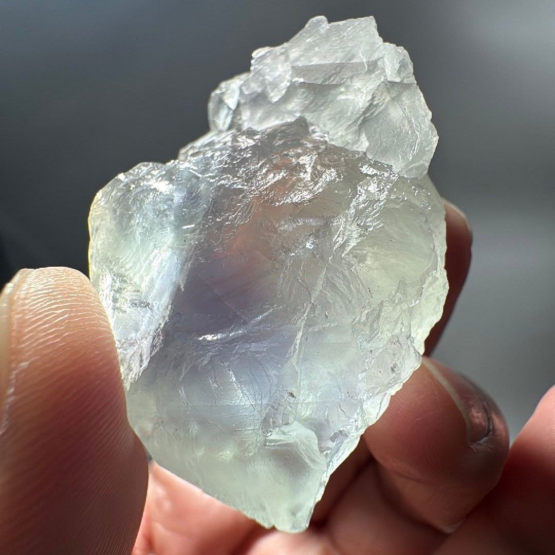 Fluorite specimen turned to show stepped cube faces and glassy transparency