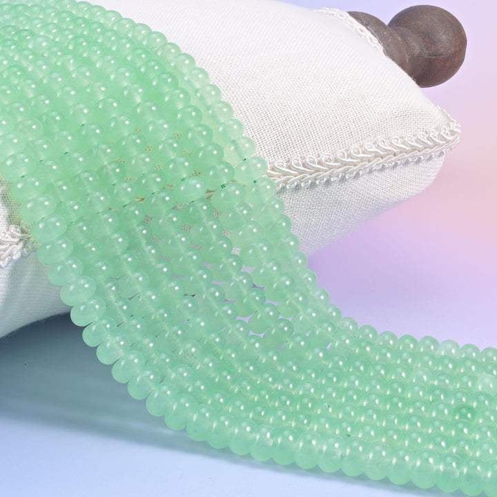Light Green Dyed Jade smooth rondelle beads in a soft apple green