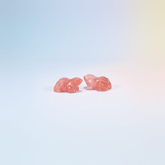 Two cherry quartz frog carvings, bright pink man-made glass
