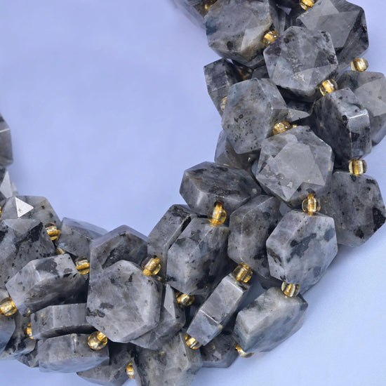 Close curve of Black Labradorite hexagons showing pale translucent patches and dark flecks