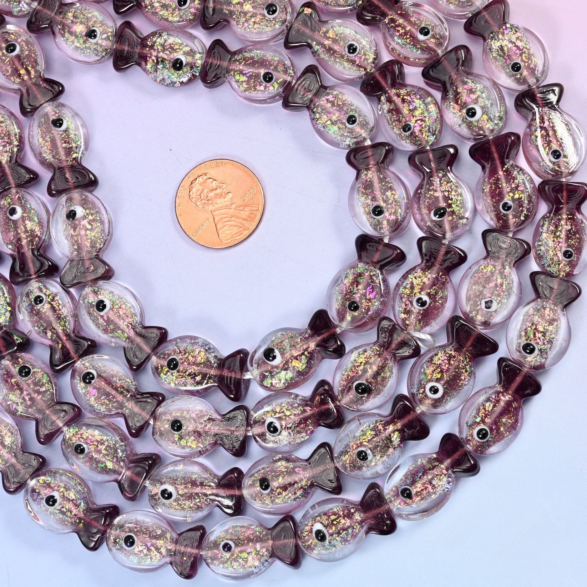 Iridescent Purple Fish Glass Beads, playful little fish moulded in clear amethyst-tinted glass
