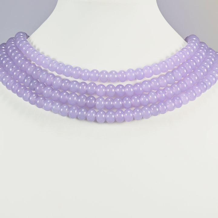 Taro Purple dyed jade gemstone rondelle beads shown on a display bust as a layered collar, several strands stepping down in a row
