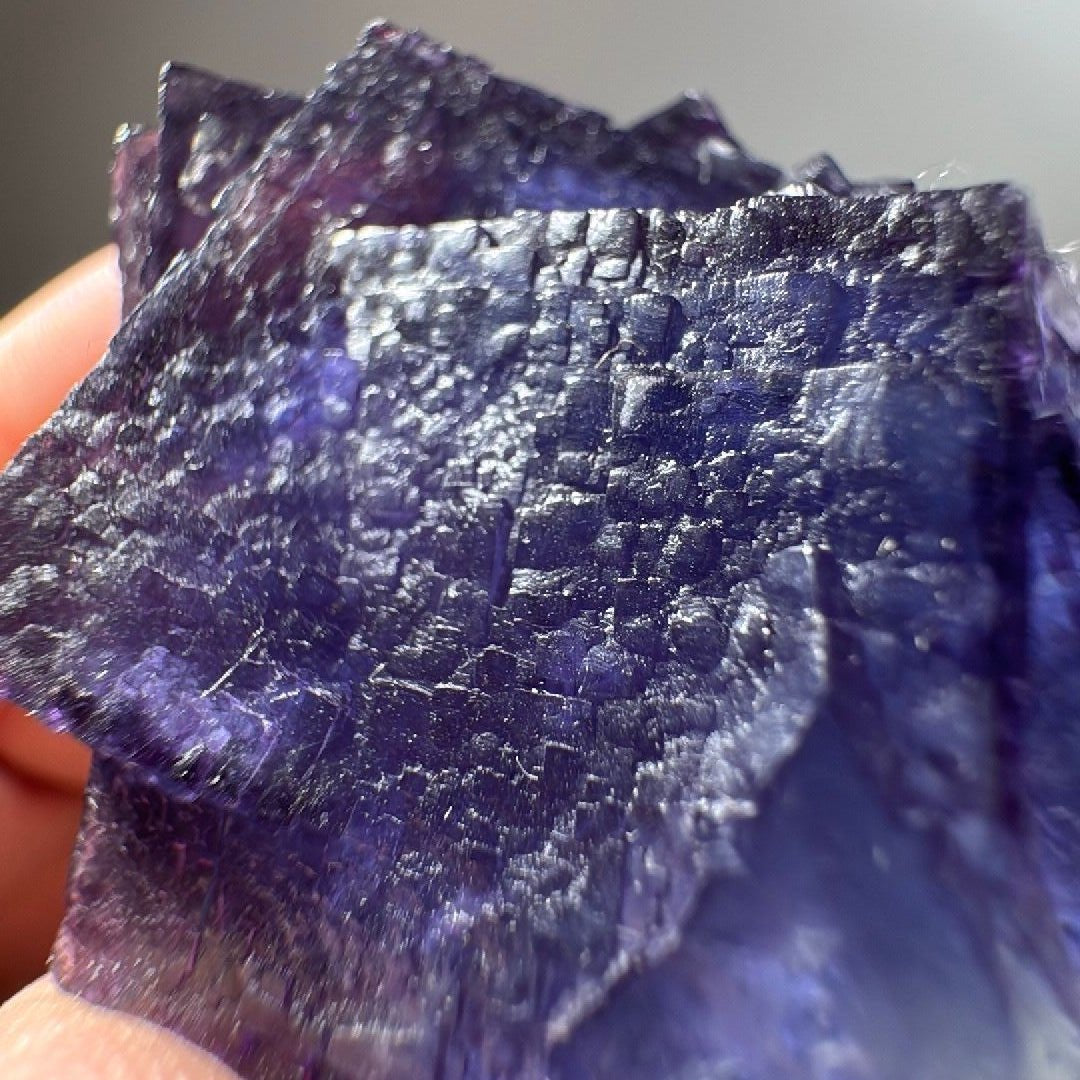 Cubic Fluorite crystal, translucent at the edges with frosted silver-grey terraced faces