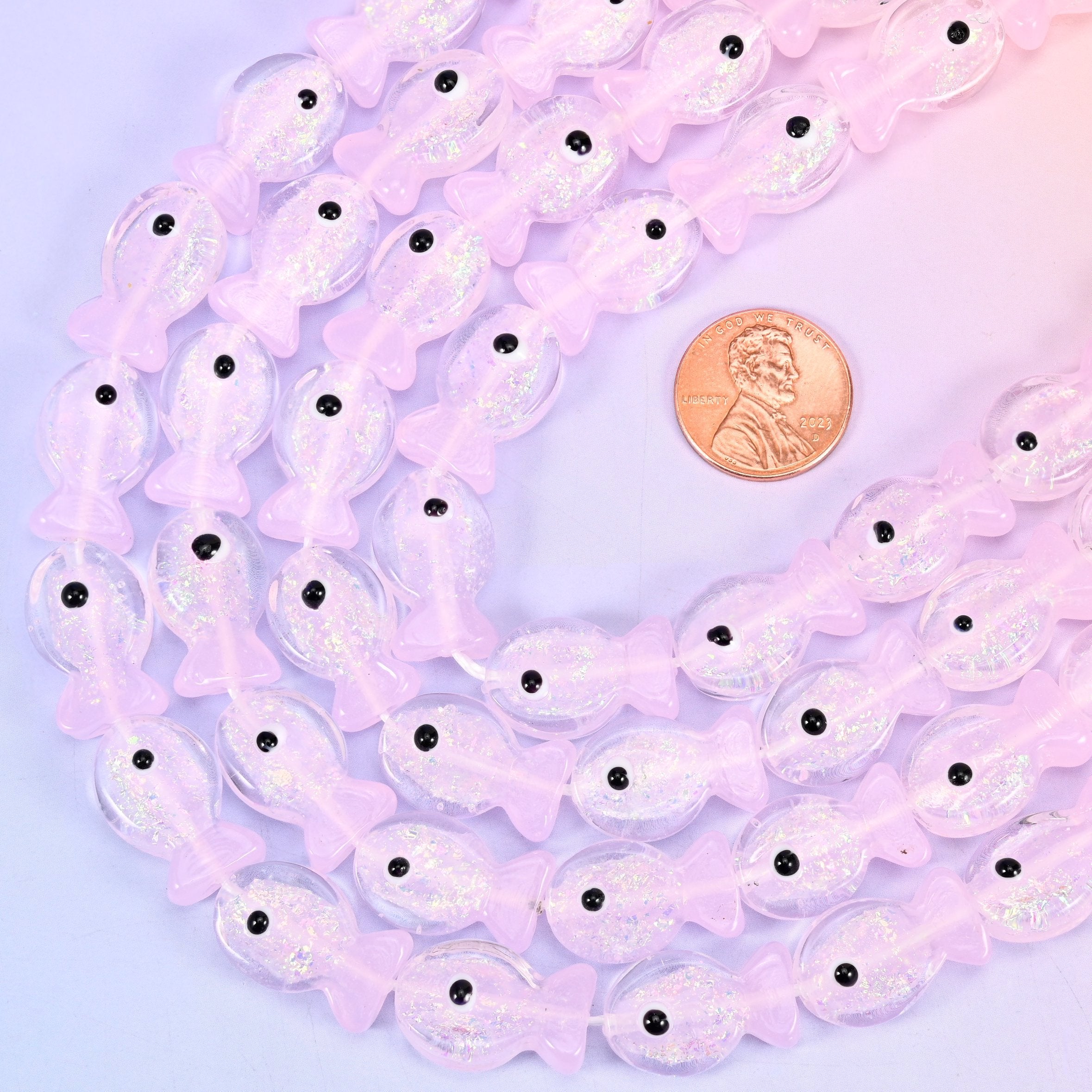 Fish shaped iridescent pink glass beads