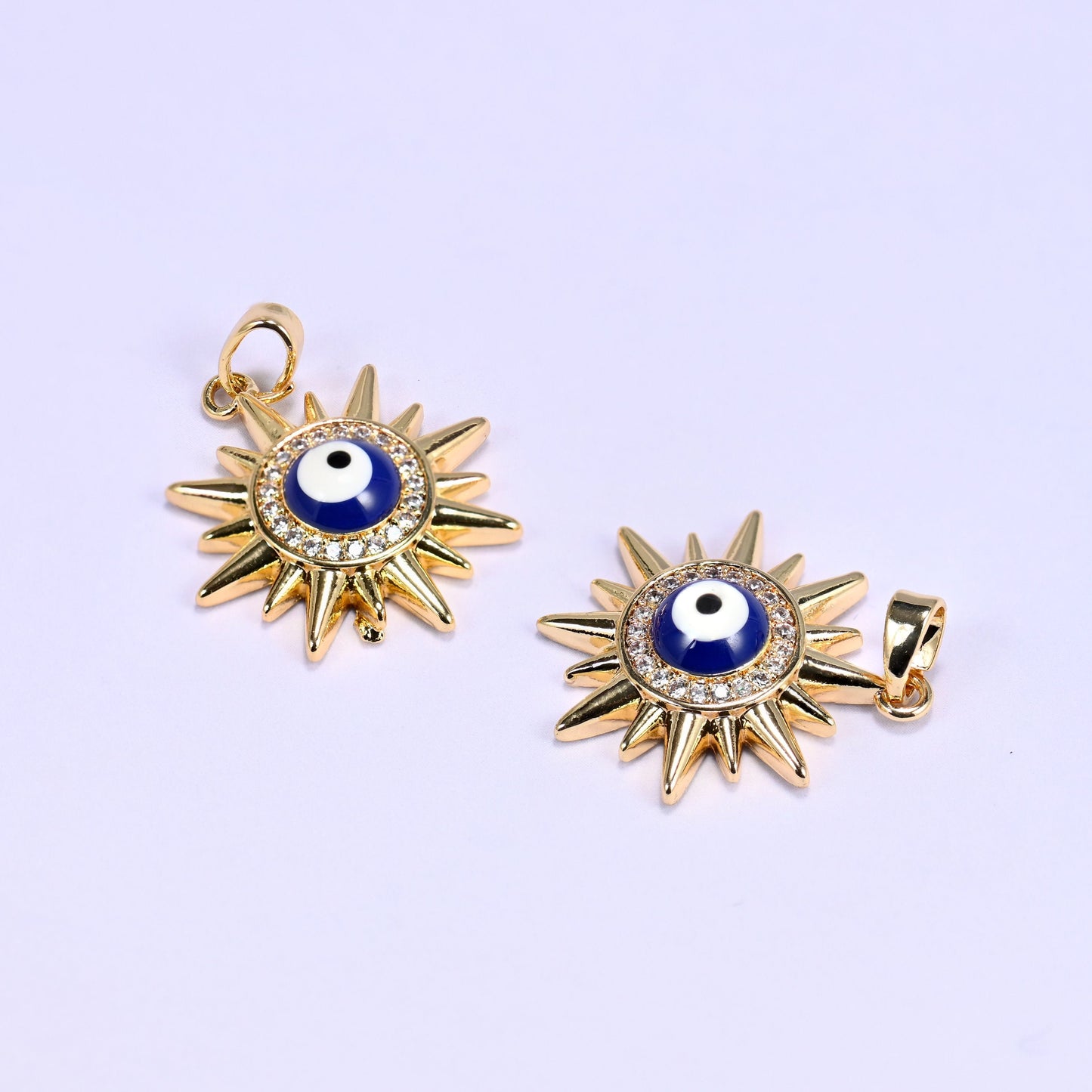 Sunburst charm with a blue and white enamel evil eye center