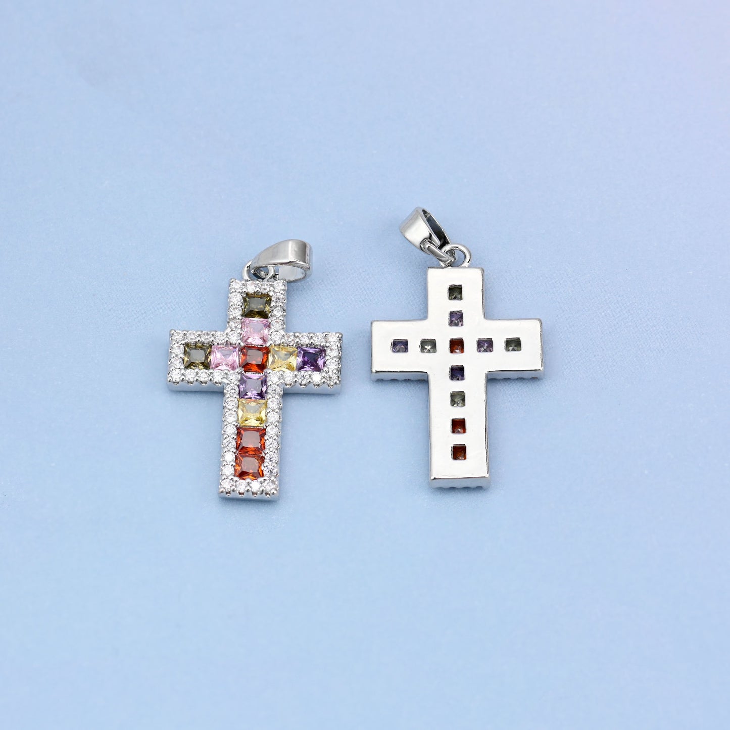 Zirconia cross charms in white gold plated brass, shown front and back with the open-back setting