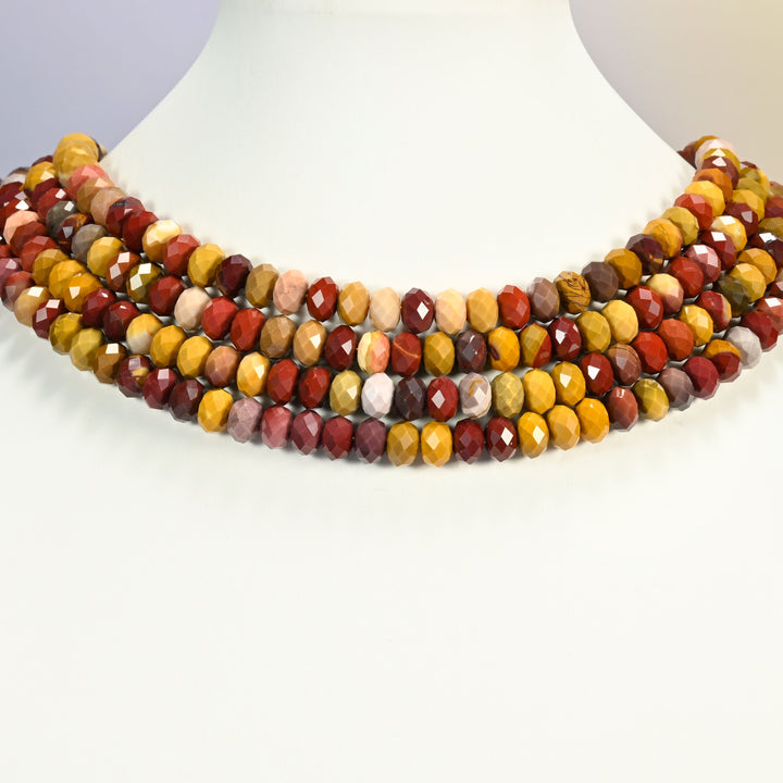 Mookaite jasper faceted rondelle beads layered as a multi-strand collar on a white neck display bust, deep red and honey.
