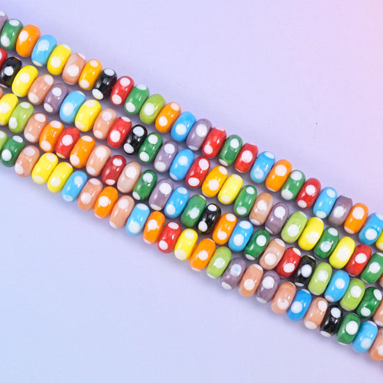 Multi-Color Donut Glass Beads in a mix of red, yellow, orange, green, blue, black, grey and sand