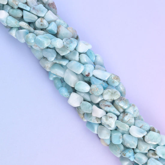Strands running off at an angle, blue and near-white beads alternating along the cord