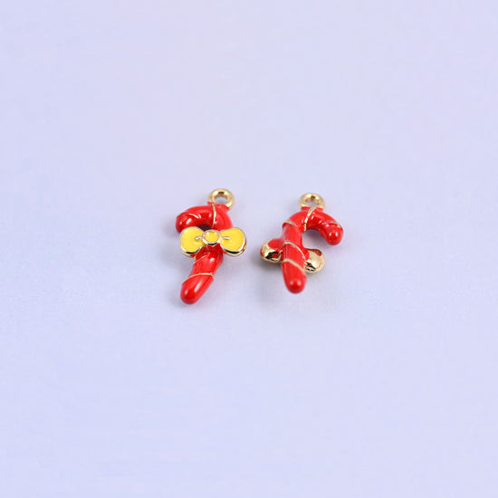 Pair of red candy cane charms standing upright, gold spiral stripe winding up each cane.
