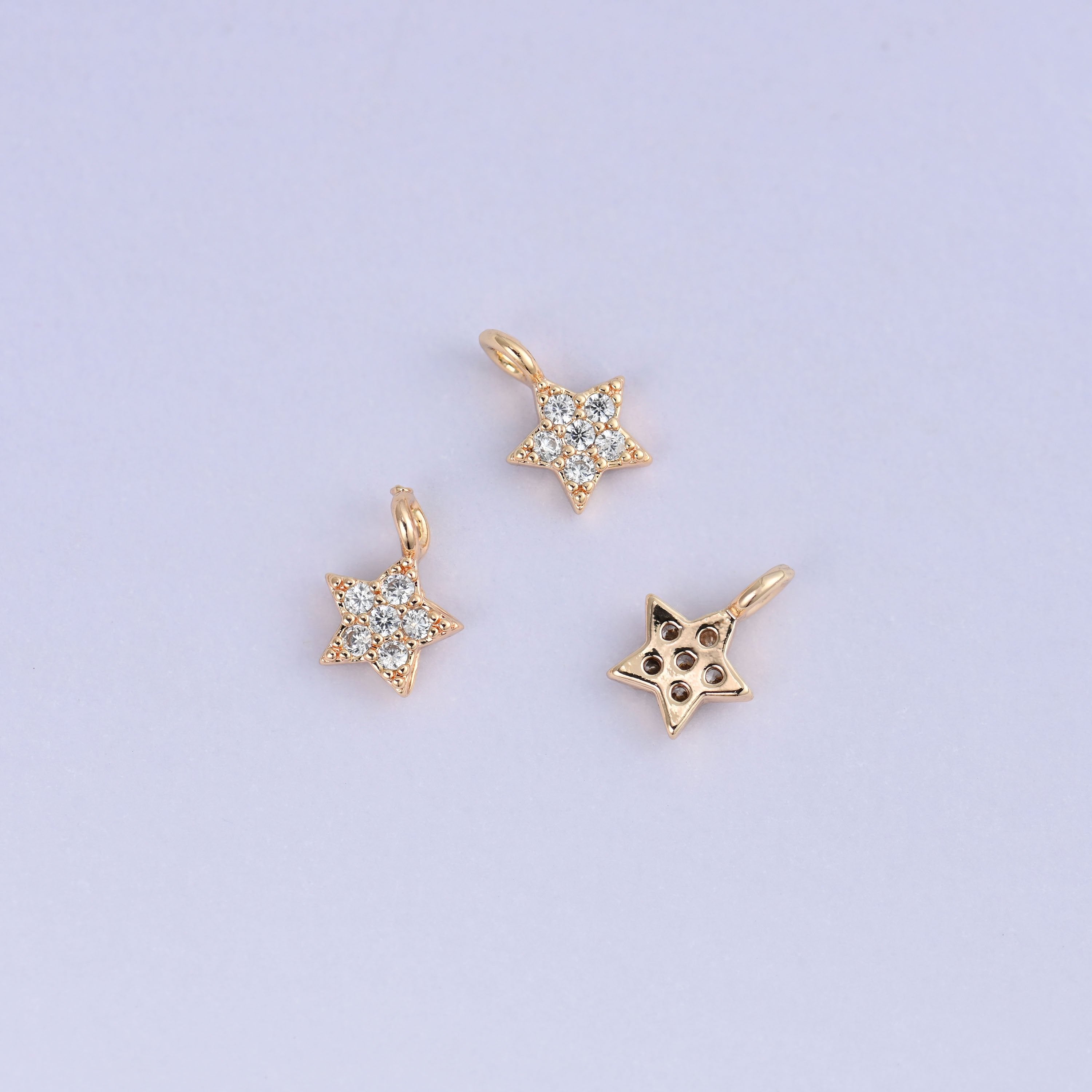 Small gold charms, three star charms with one turned to show the back