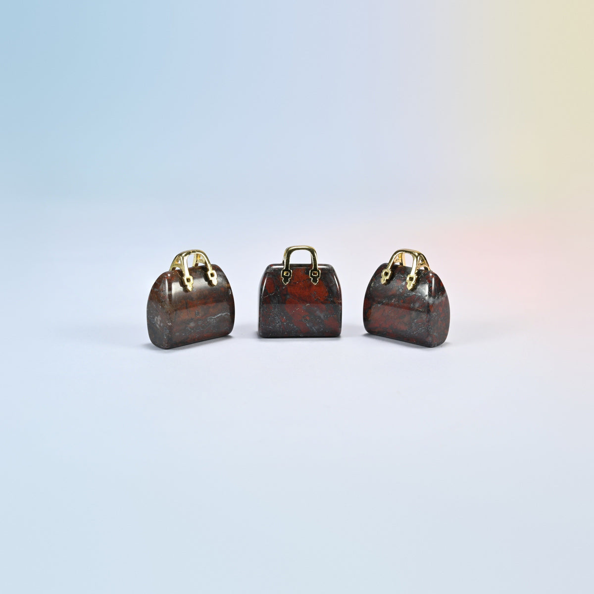 Three Zhanguo agate purse crystal carvings, 1 inch, dark red-brown natural agate with brick-red patches, gold-tone handle