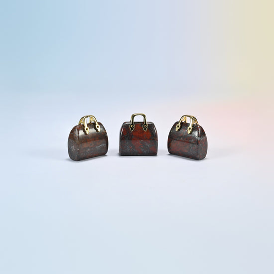 Three Zhanguo agate purse crystal carvings, 1 inch, dark red-brown natural agate with brick-red patches, gold-tone handle