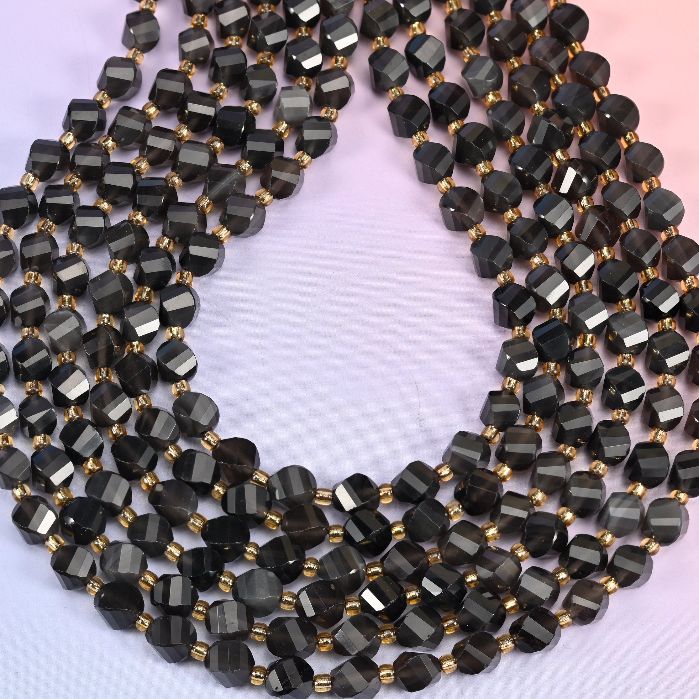 Ice obsidian natural stone beads polished to a glassy finish, light passing through the translucent beads