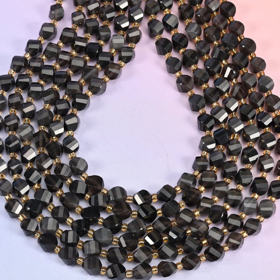 Ice obsidian natural stone beads polished to a glassy finish, light passing through the translucent beads