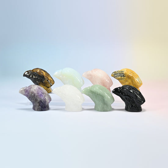 Eight 2 inch eagle head crystal carvings in natural tiger eye, rose quartz, crazy agate, amethyst, clear quartz, green aventurine, black obsidian and opalite
