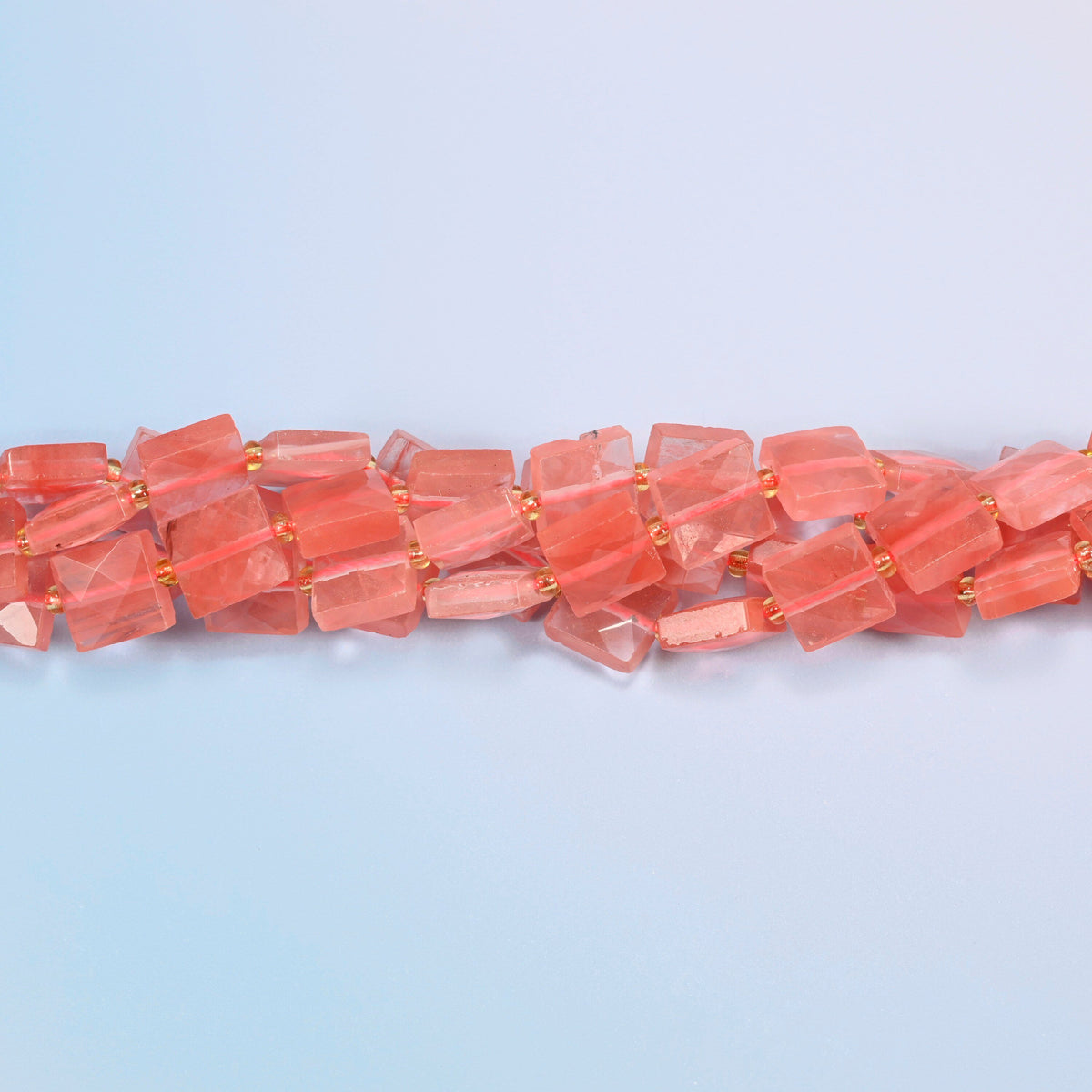 Strands of melon quartz faceted flat square beads twisted together in a horizontal row