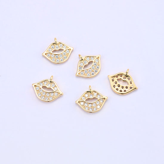 Small gold charms, five lip charms with one turned over to show the back