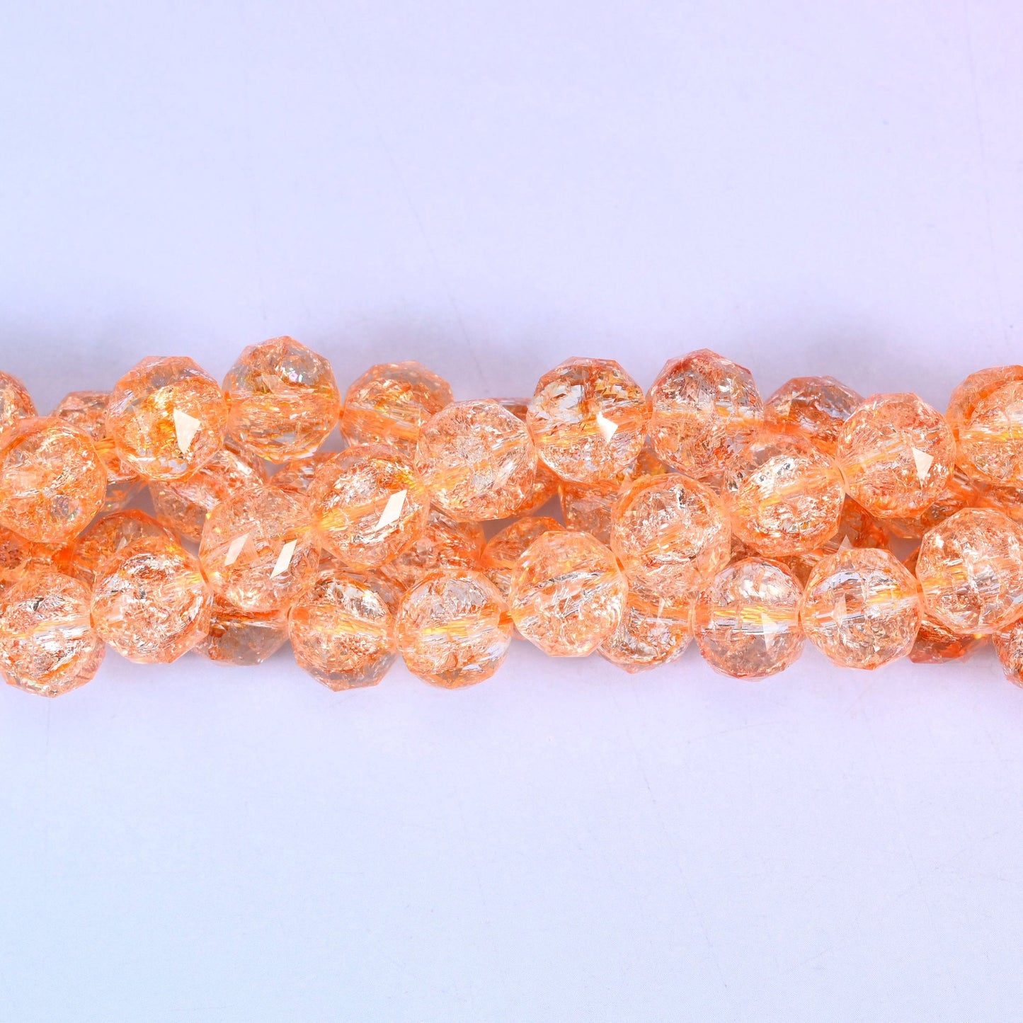 Transparent orange faceted round glass beads, approximately 42 beads per strand