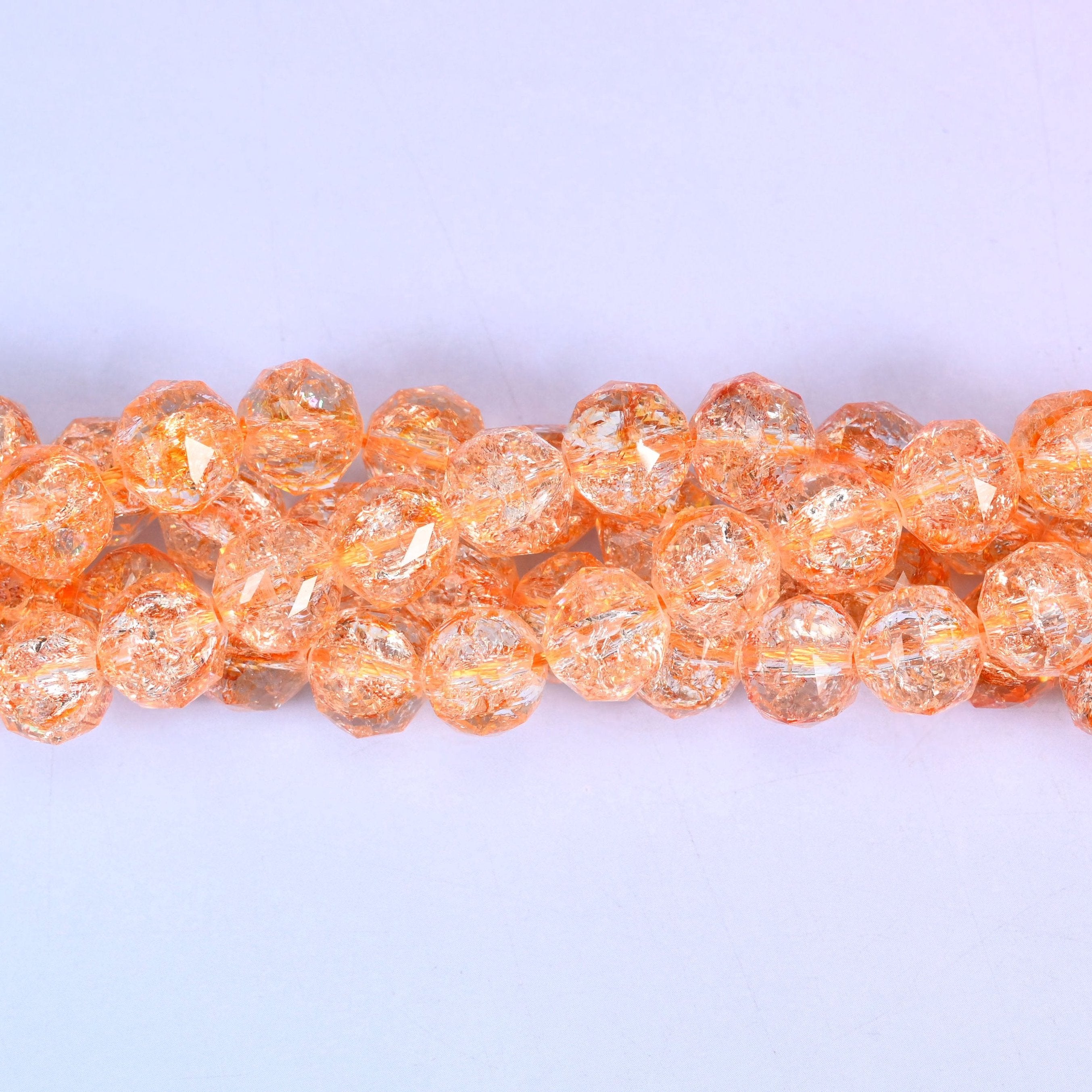Transparent orange faceted round glass beads, approximately 42 beads per strand
