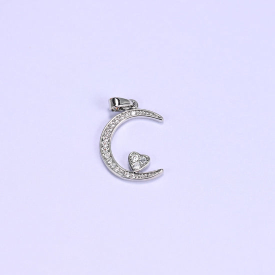 Moon heart zirconia charm in silver tone, a single crescent moon pendant paved with clear stones and a small heart in the curve.