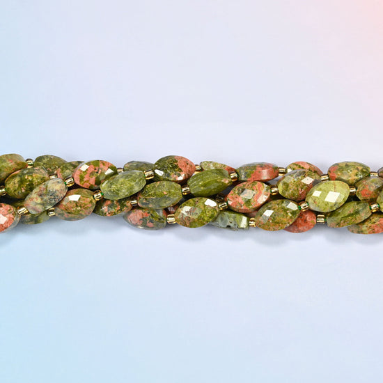 Strands of unakite faceted flat oval beads twisted together in a horizontal row