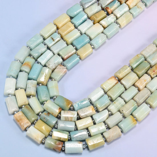 Multi-Color Amazonite faceted tube beads curving in a wide U across the frame, light blue and green shading into cream and yellow