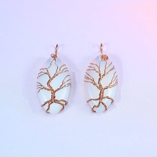 Oval Crystal Pendant with Copper Wired Tree in milky opalescent white, a pair showing the fine copper branch work across the light surface.