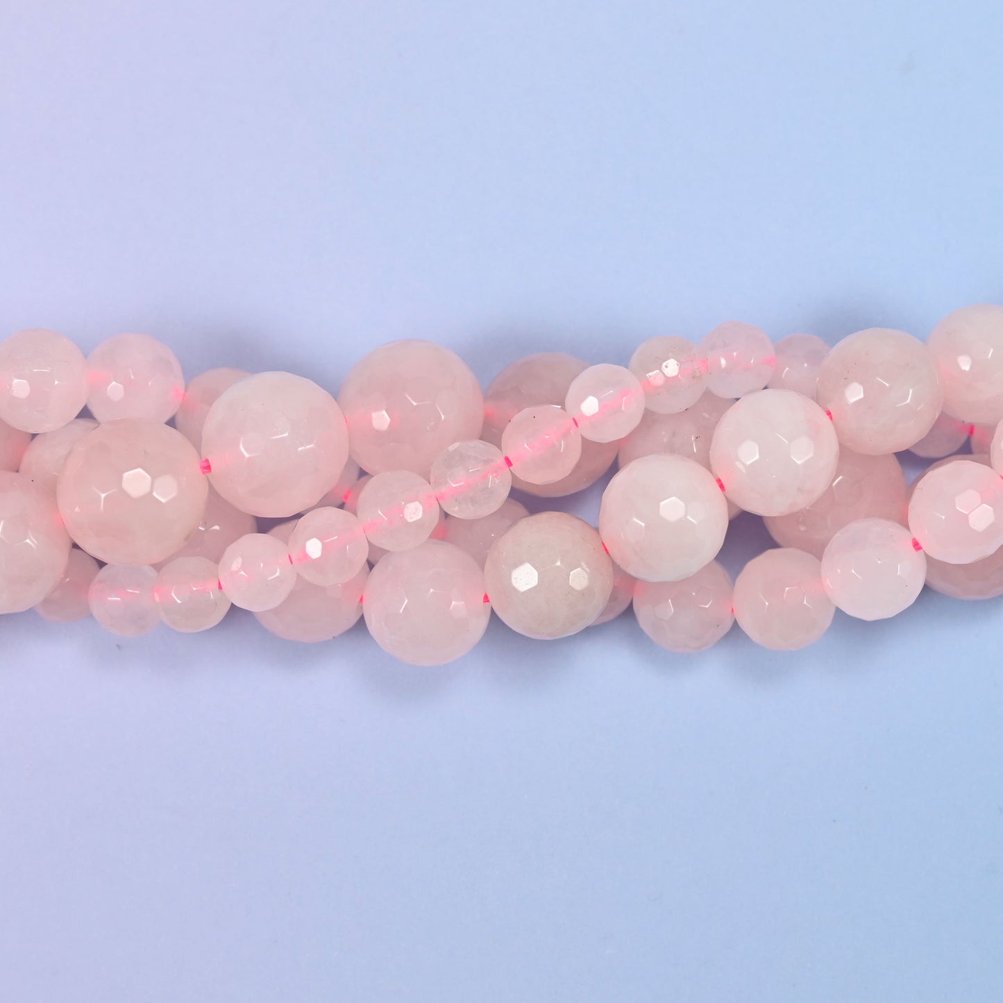 End detail of a pink rose quartz beaded strand (15-inch strand), showing bead spacing.