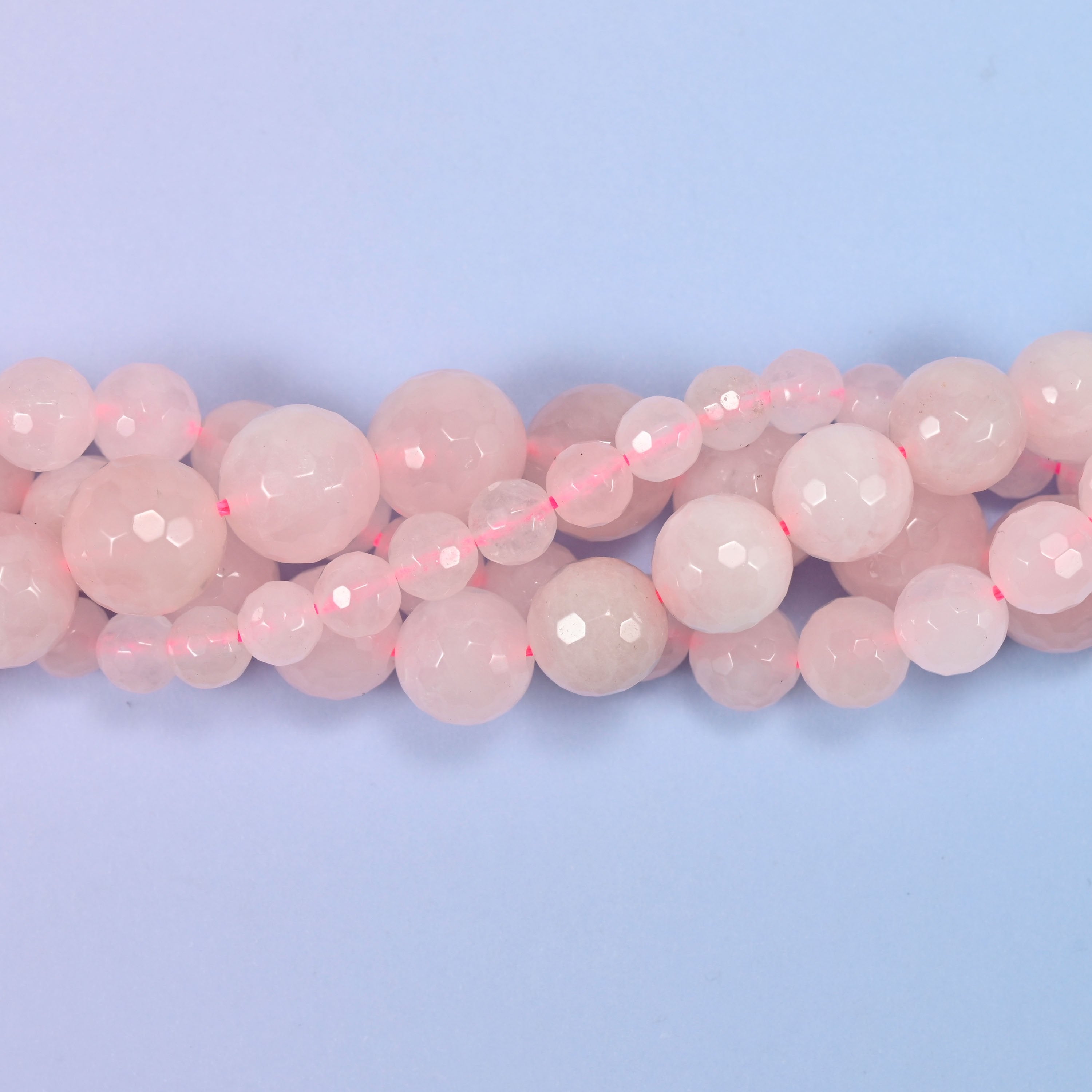 End detail of a pink rose quartz beaded strand (15-inch strand), showing bead spacing.