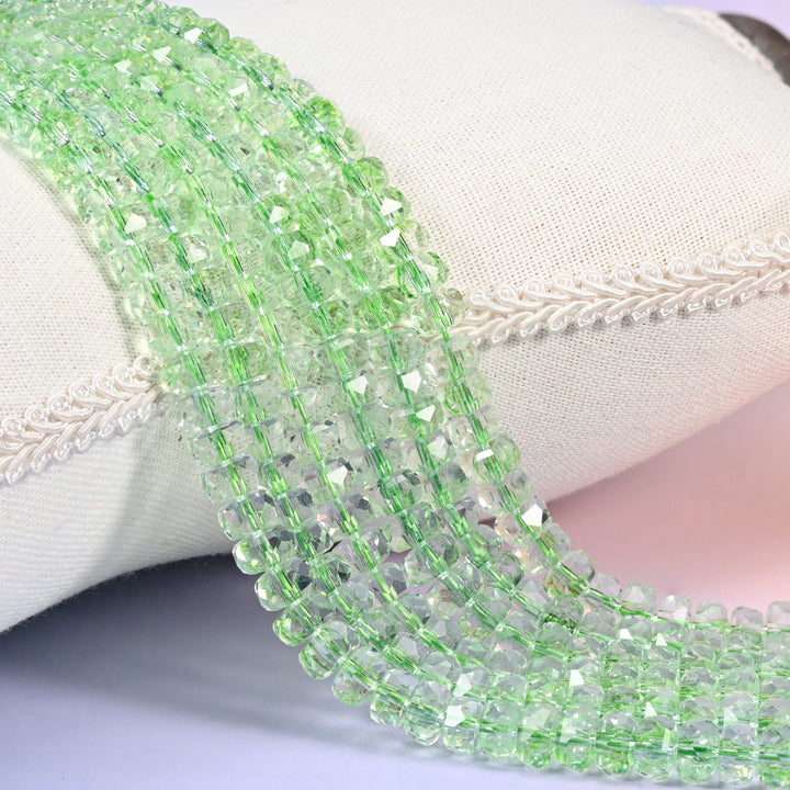 Transparent green faceted rondelle glass beads in crisp apple green, see-through with tight facets