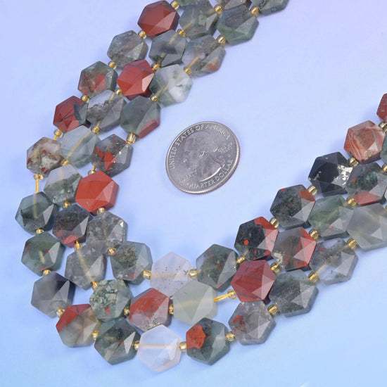 African Bloodstone hexagon strands beside a coin for size reference