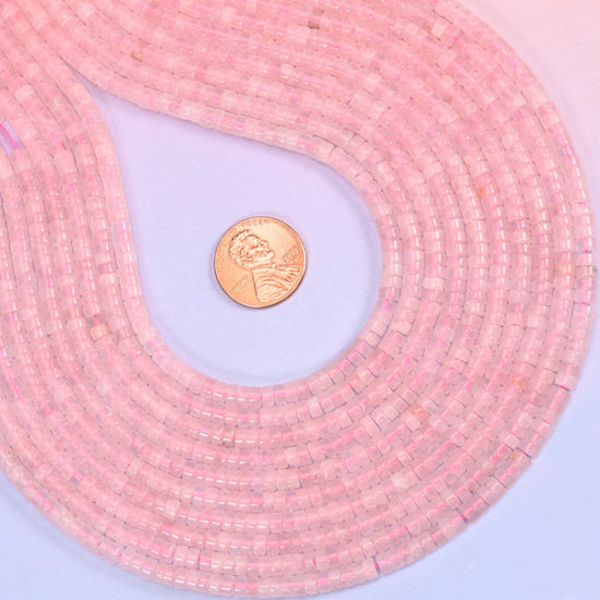 Natural Rose Quartz smooth heishi disc beads in soft to vivid pink with a translucent glow, finished with a polished, sophisticated look.