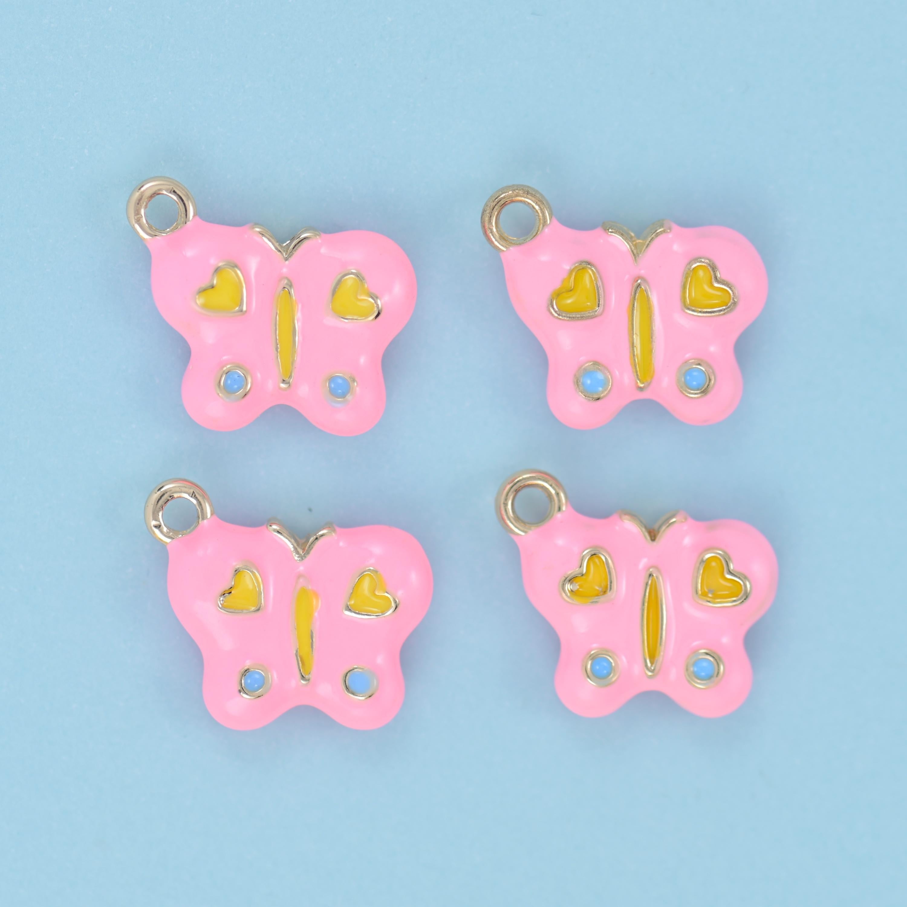 A rounded butterfly filled with soft pastel enamel, decorated with two little hearts on the upper wings