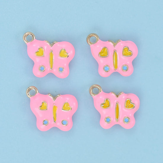A rounded butterfly filled with soft pastel enamel, decorated with two little hearts on the upper wings