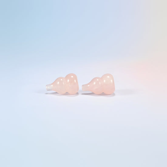 Two natural rose quartz wu lou gourds lying down showing the double bulb shape