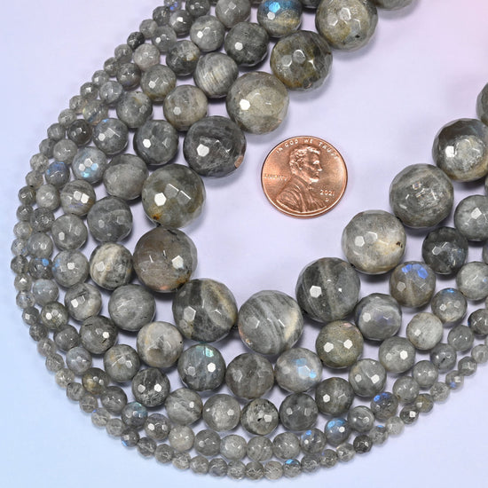 Gray Labradorite faceted round beads in a deep loop, shown at their true size of 4mm to 14mm