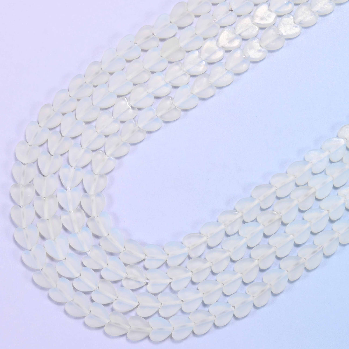 Matte Opalite Flat Heart Beads in milky white with a pale ice-blue glow