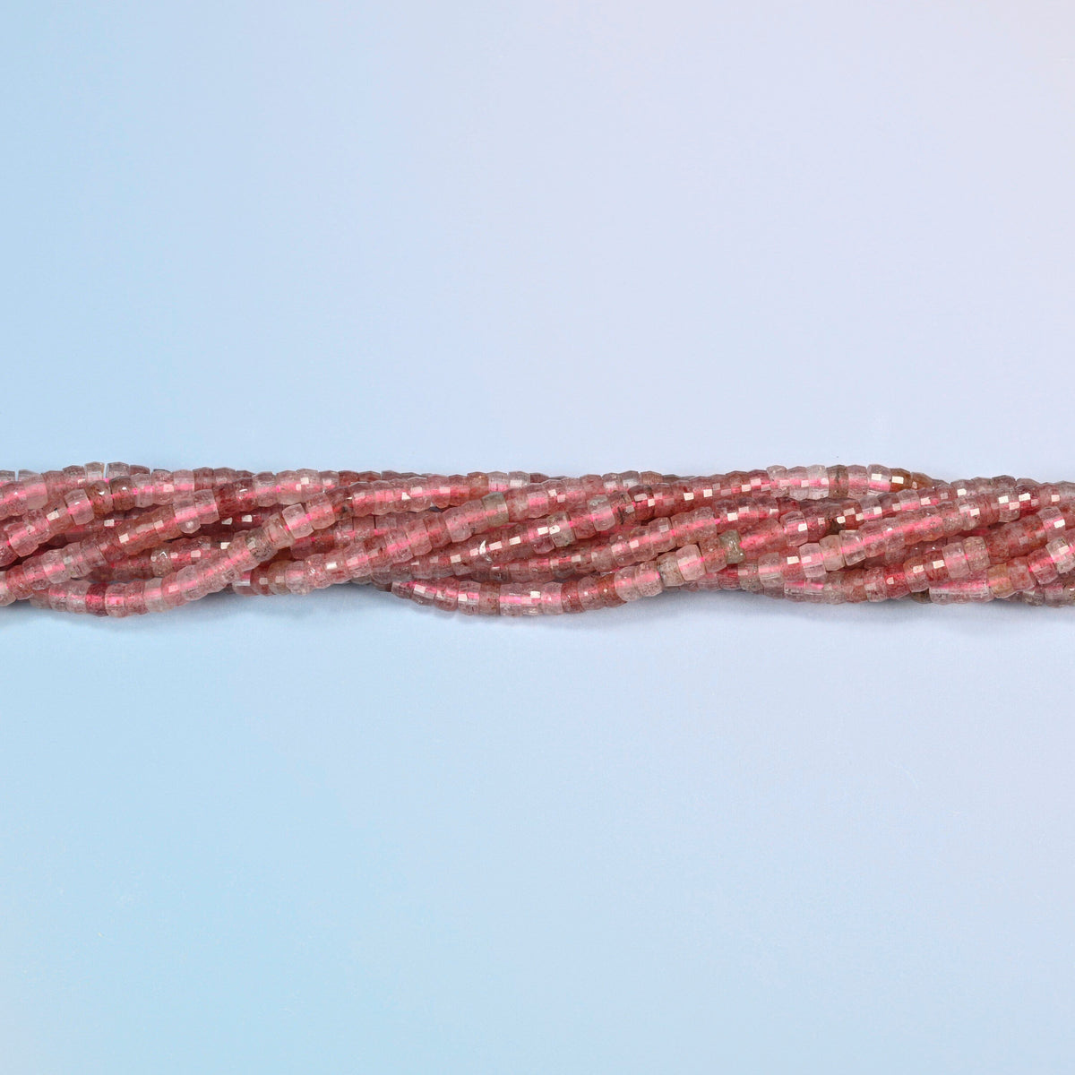 Strands of strawberry quartz faceted heishi disc beads twisted together in a horizontal row